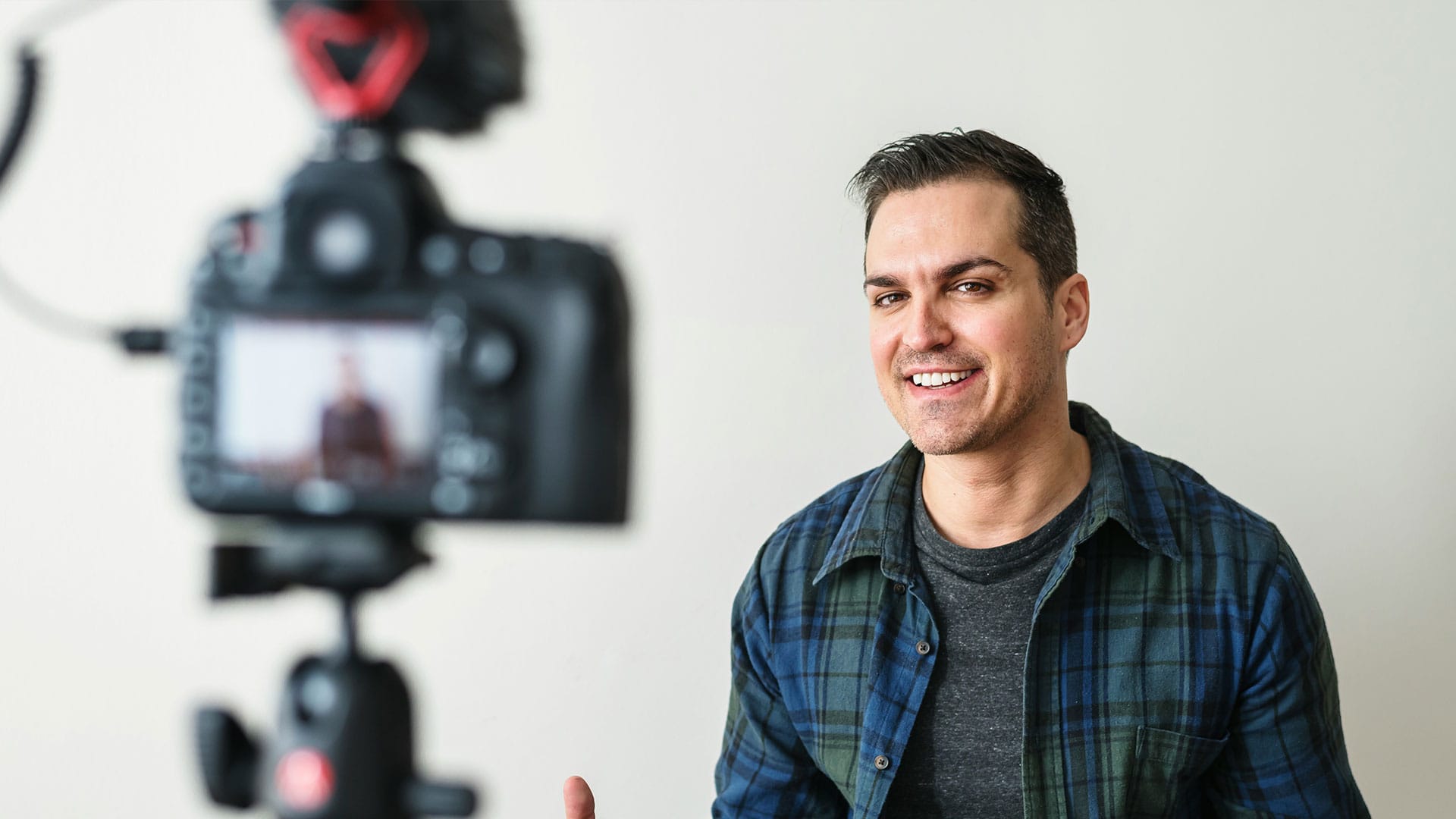 Junge Frau richtet Smartphone in Ringlicht aus für eine Aufnahme im Stil von User-Generated Content im Unternehmensvideo